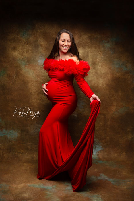 robe rouge moulante pour un shooting glamour de grossesse au studio de Karine Majet