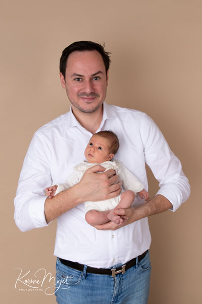 photo d'un père avec sa fille dans les bras les tous premiers jours après la naissance